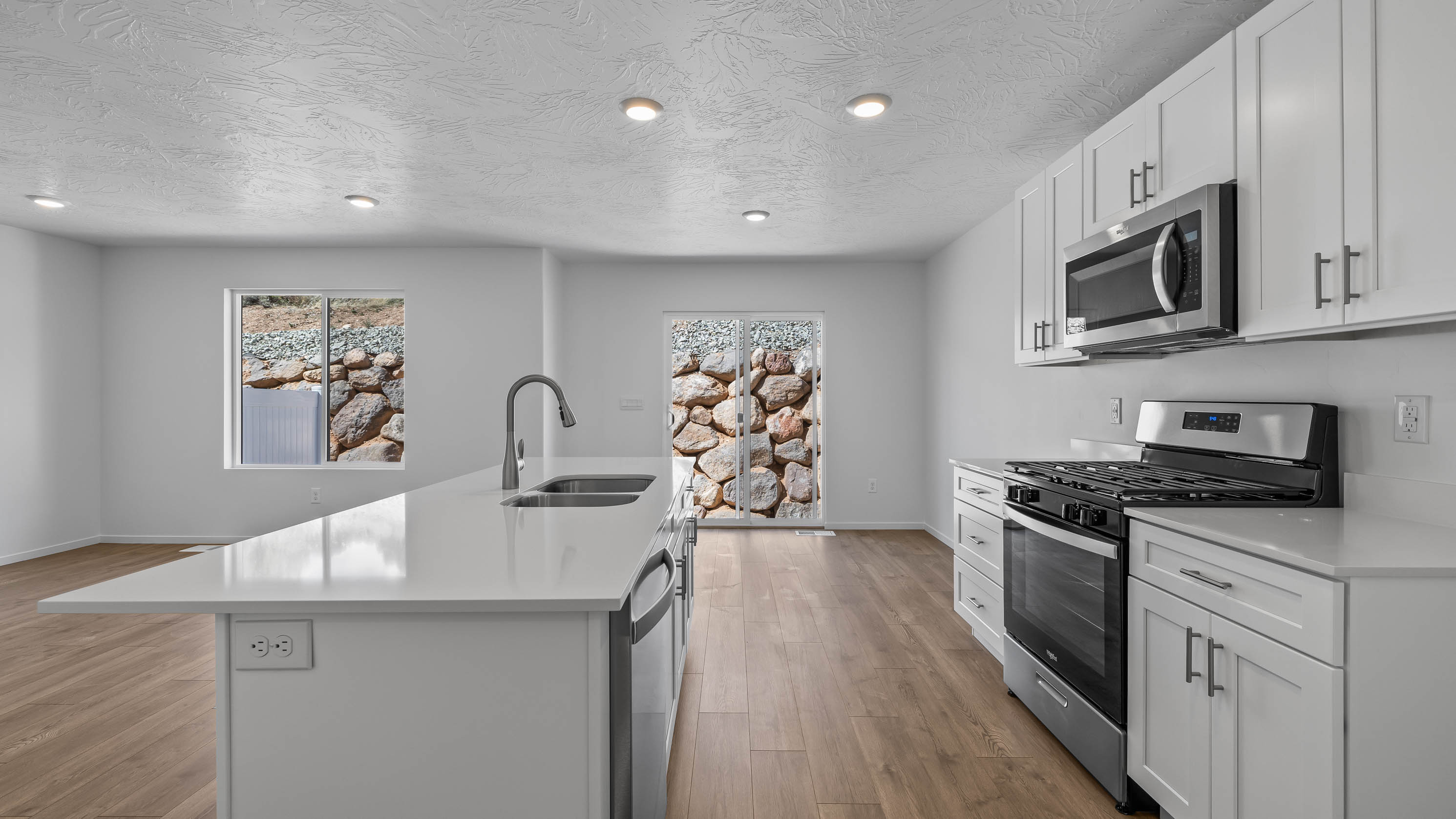 Spacious kitchen with quartz countertops, kitchen island, and pantry