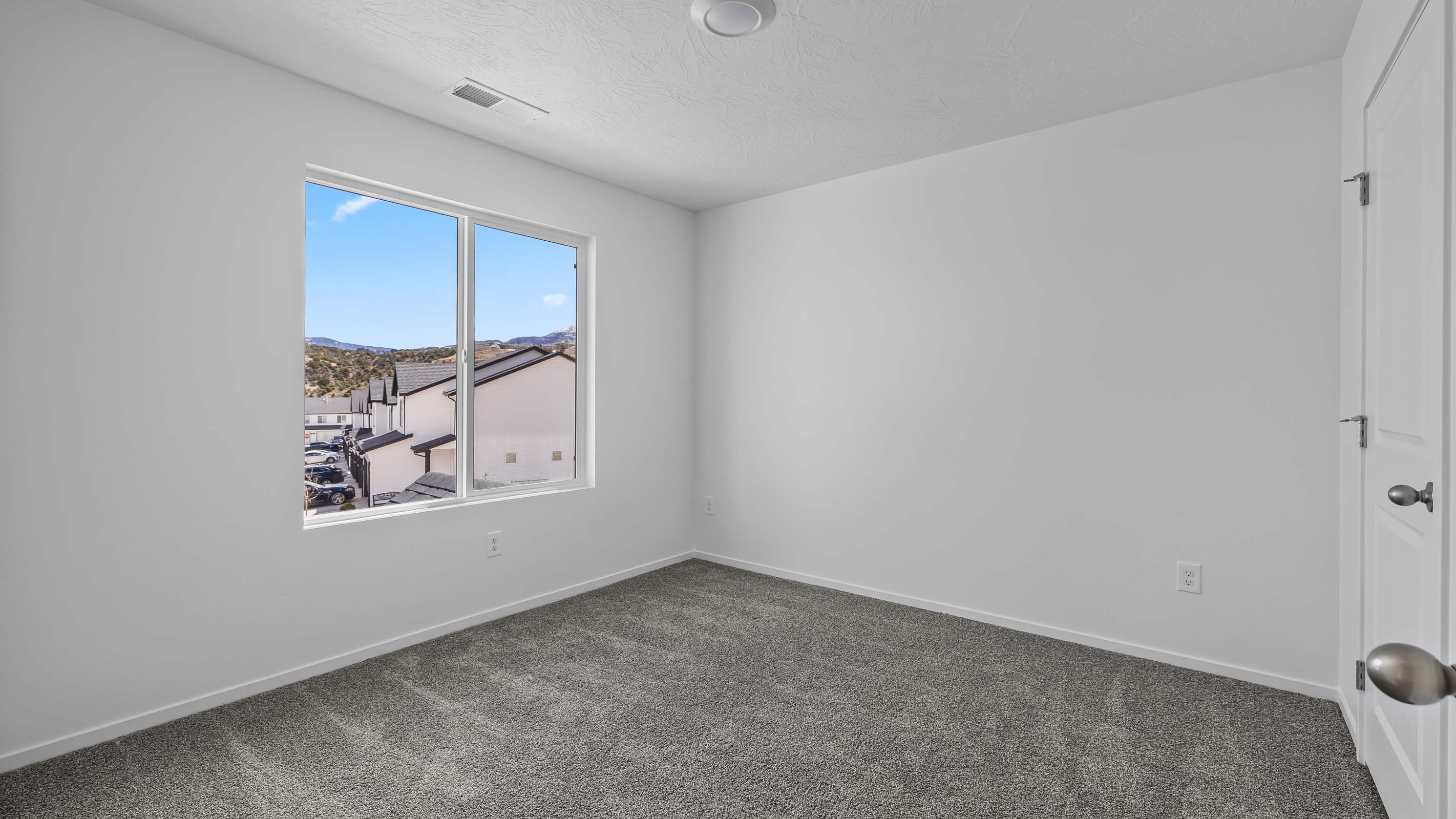 Spacious bedroom with large window