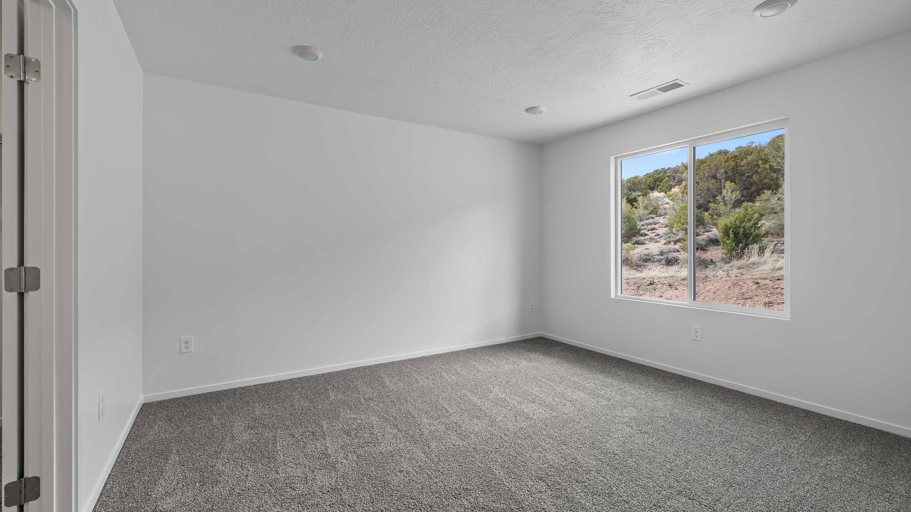 Spacious bedroom with large window