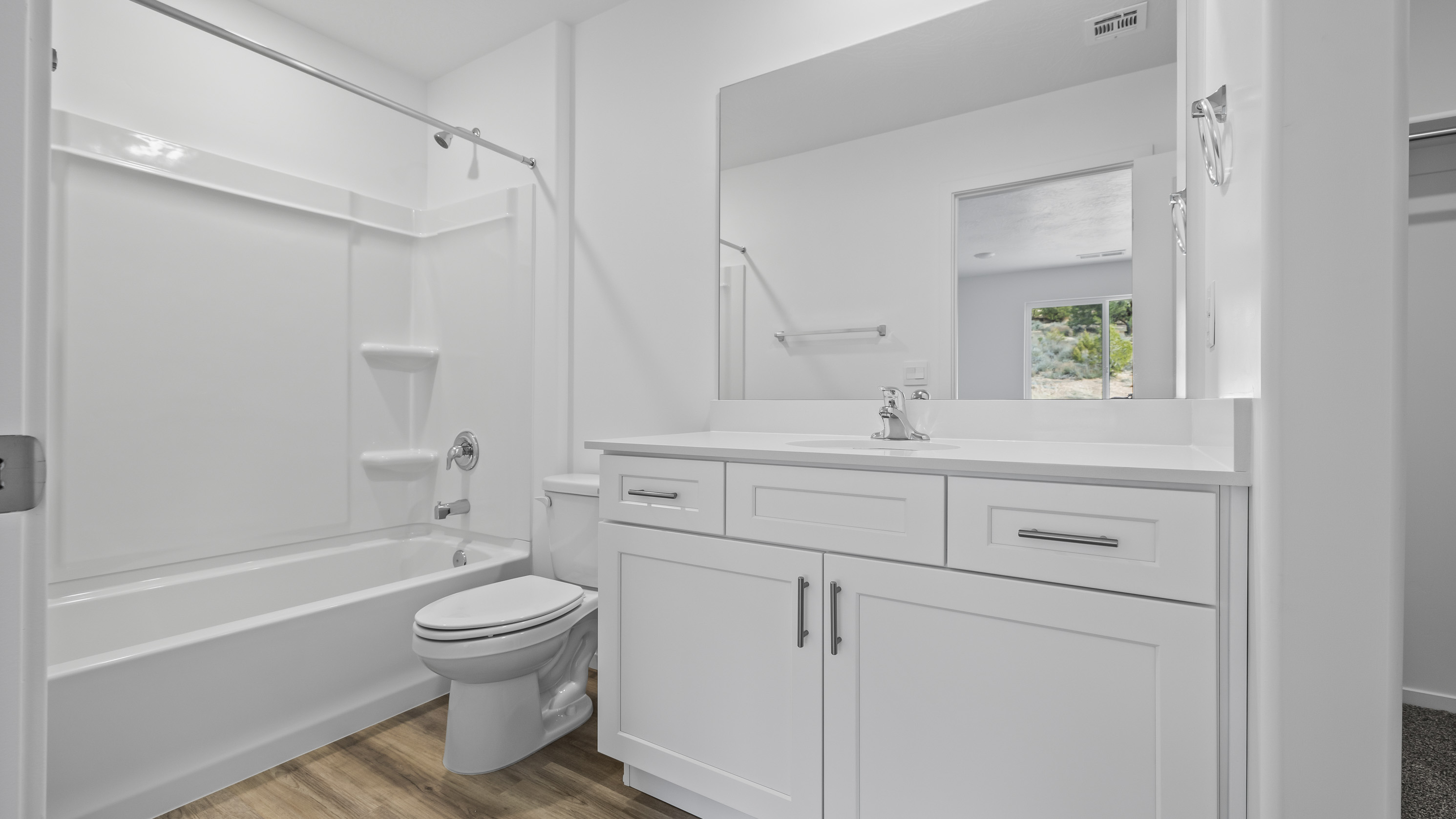Bathroom with quartz countertops and a tub shower combo