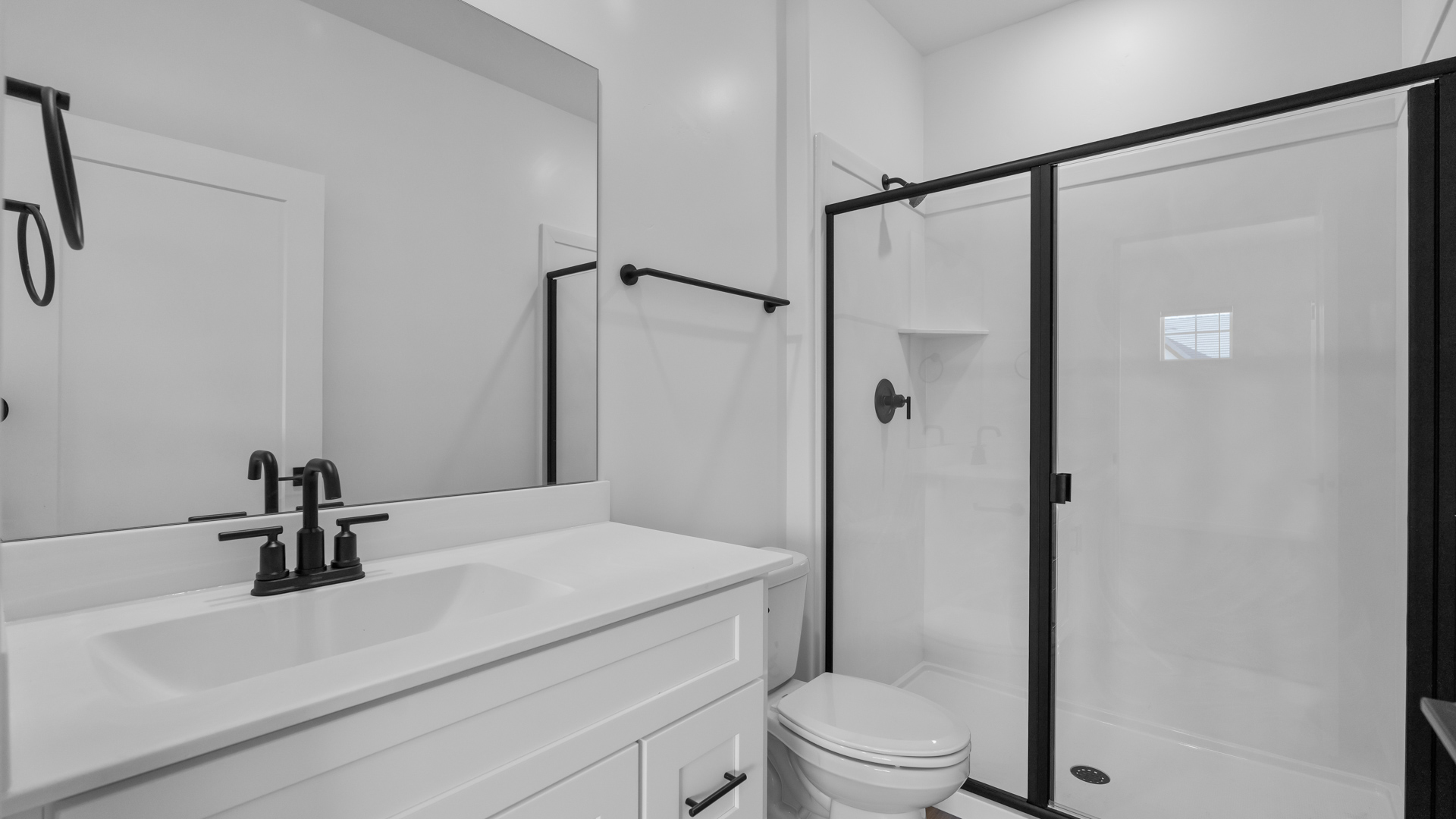 Bathroom featuring white cabinets and countertops.