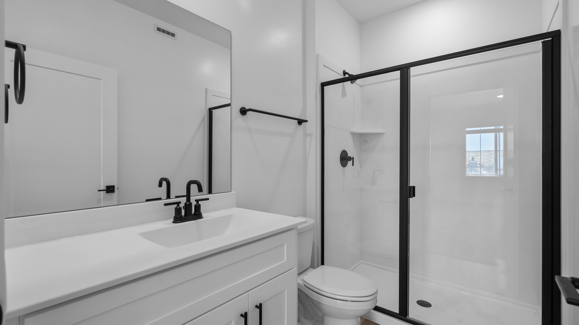 Bathroom featuring white cabinets and countertops.