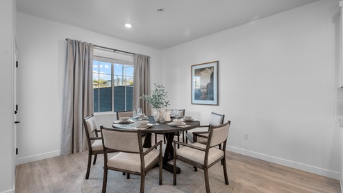 Dining room with large window and door leading out to patio.