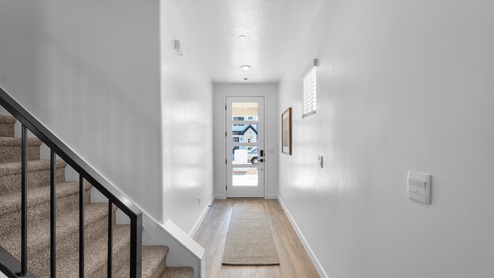 Crescent model home entryway with windows on front door.