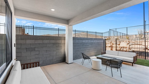 Back of home with covered patio.