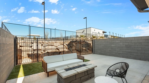 Back of home with covered patio.