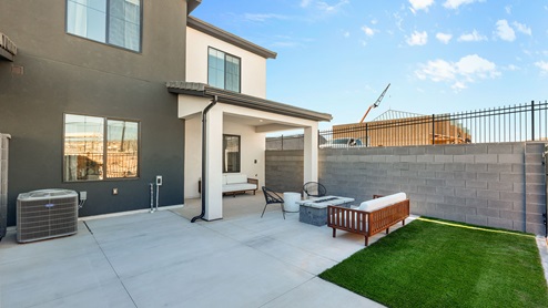 Back of home with covered patio.