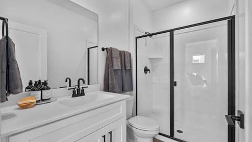 Primary bathroom featuring white cabinets and countertops.