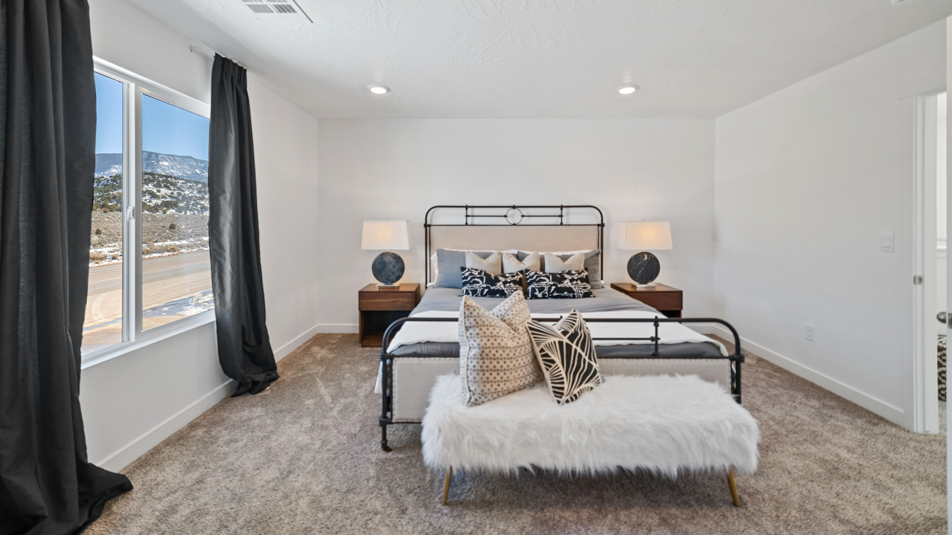 Primary bedroom with large window.