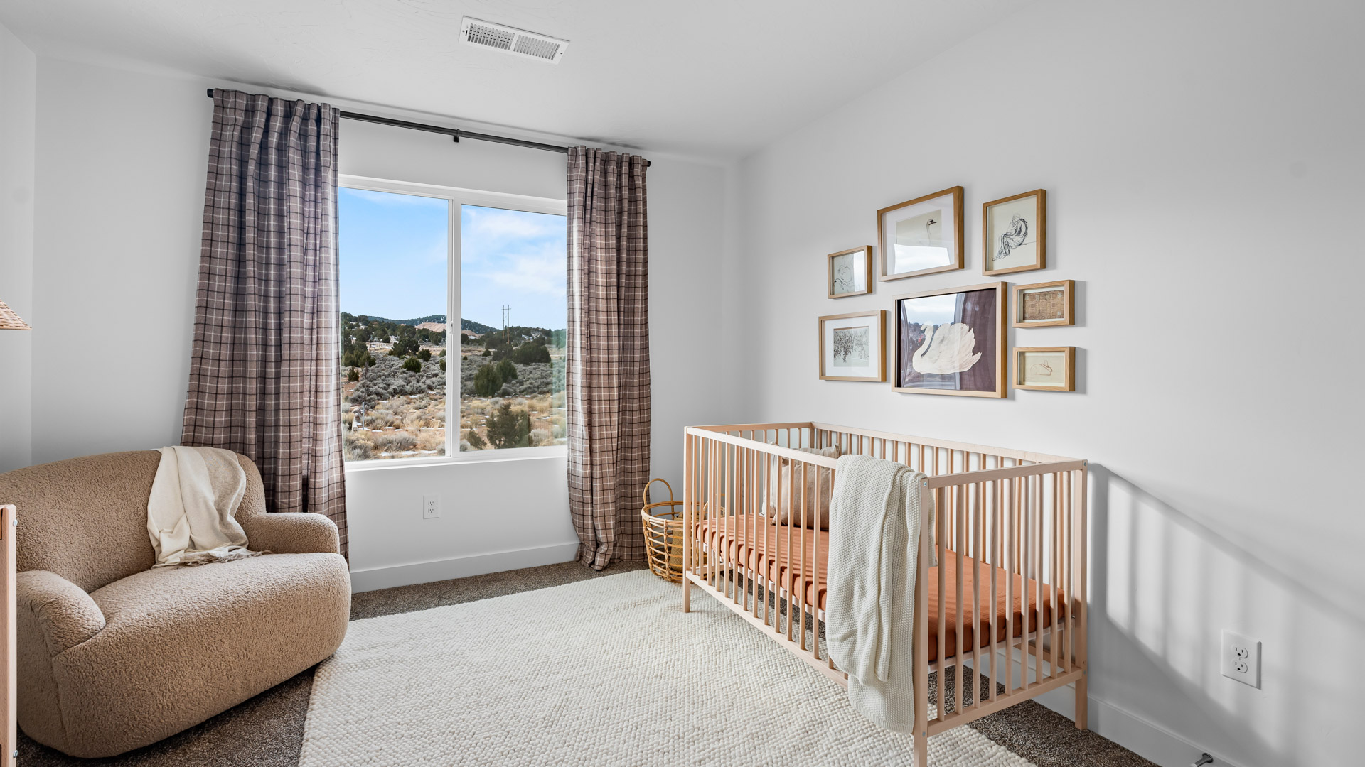 Bedroom with large window and square window in corner.