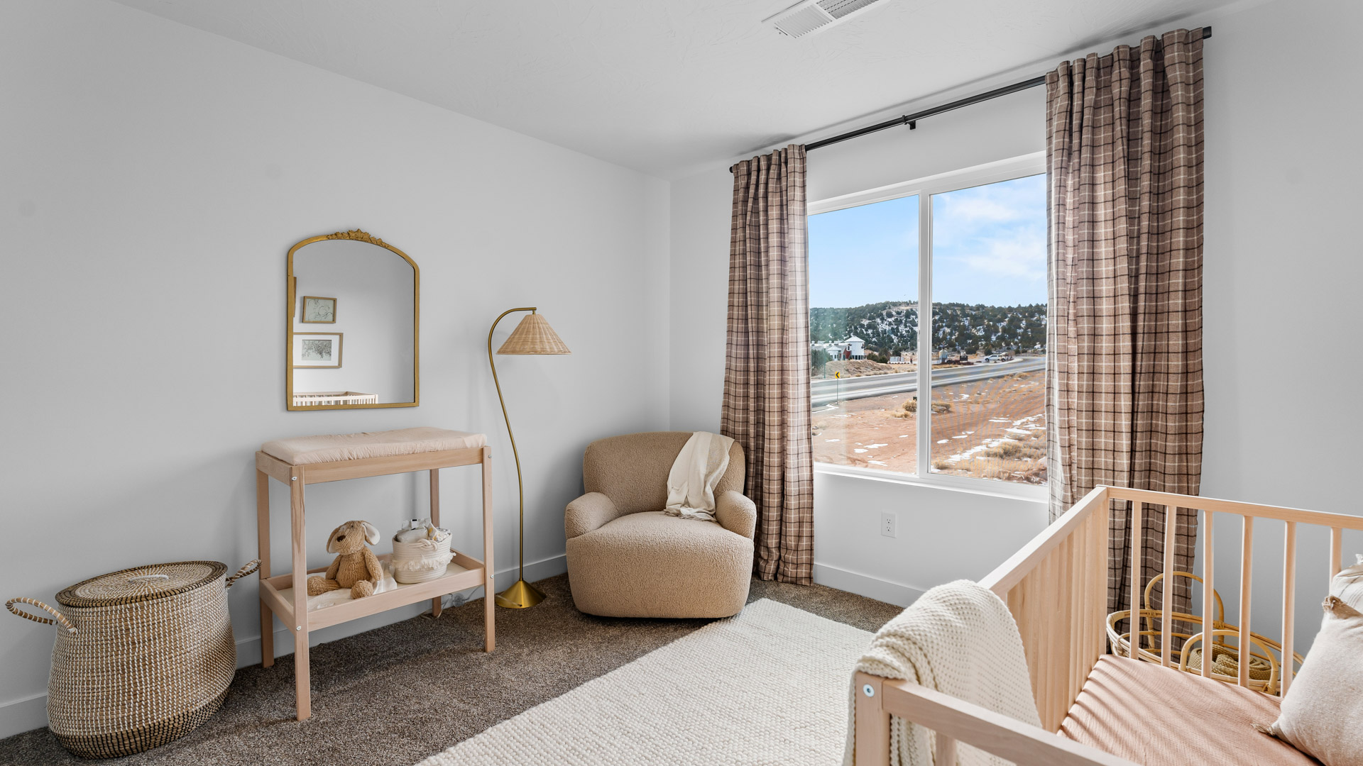 Bedroom with large window and square window in corner.