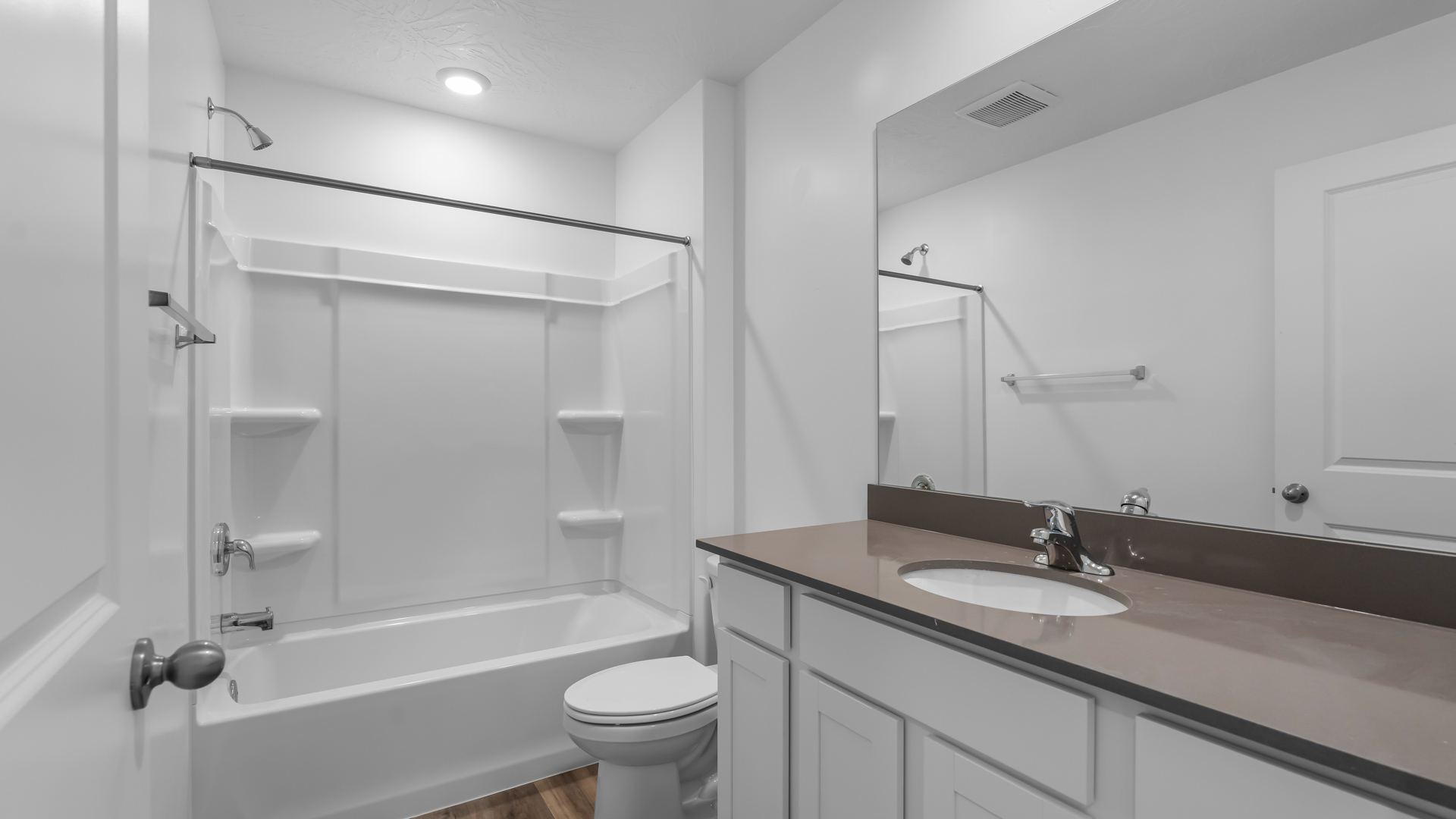Bathroom with vanity and shower surround.