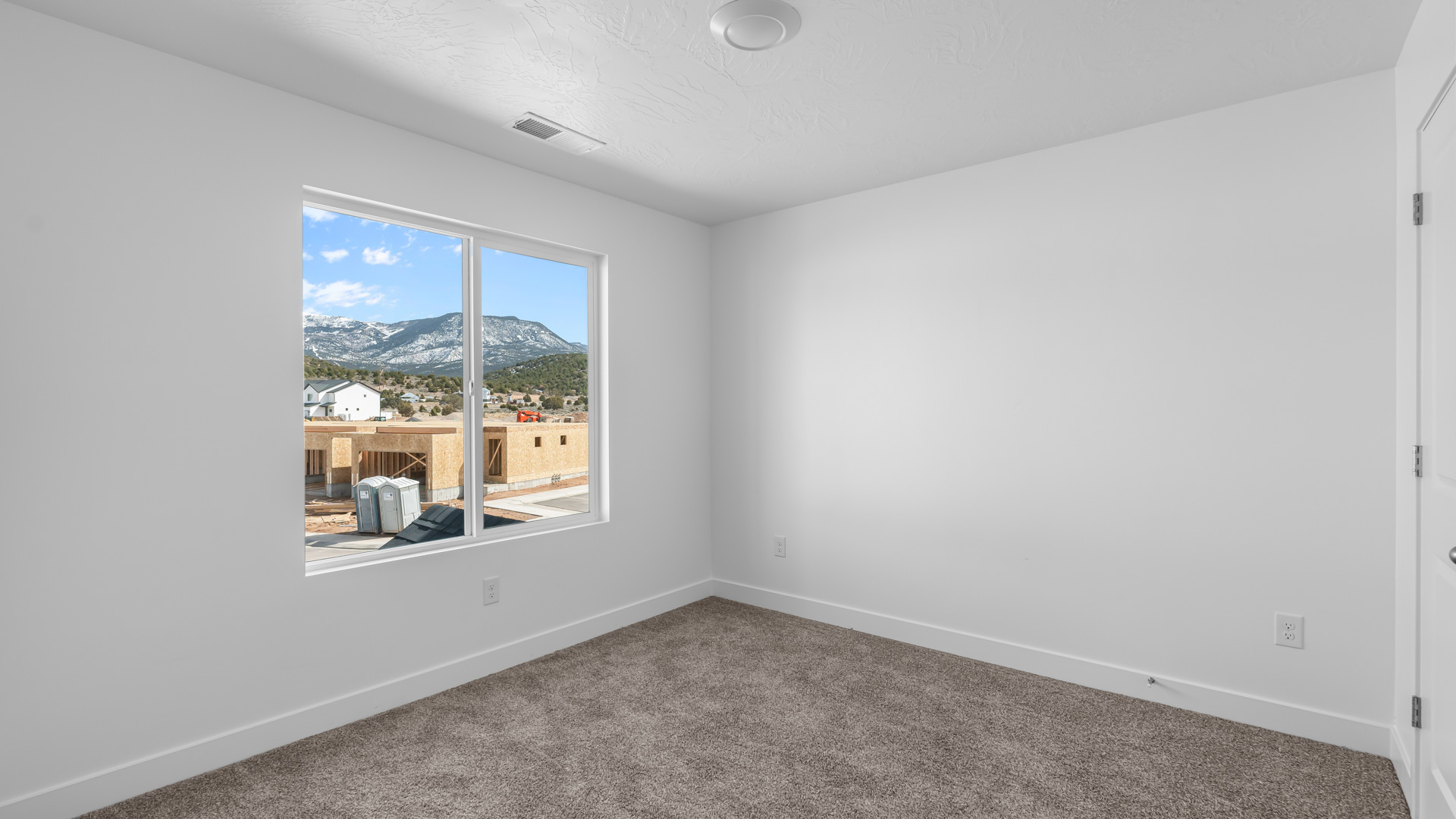 Bedroom with large window.
