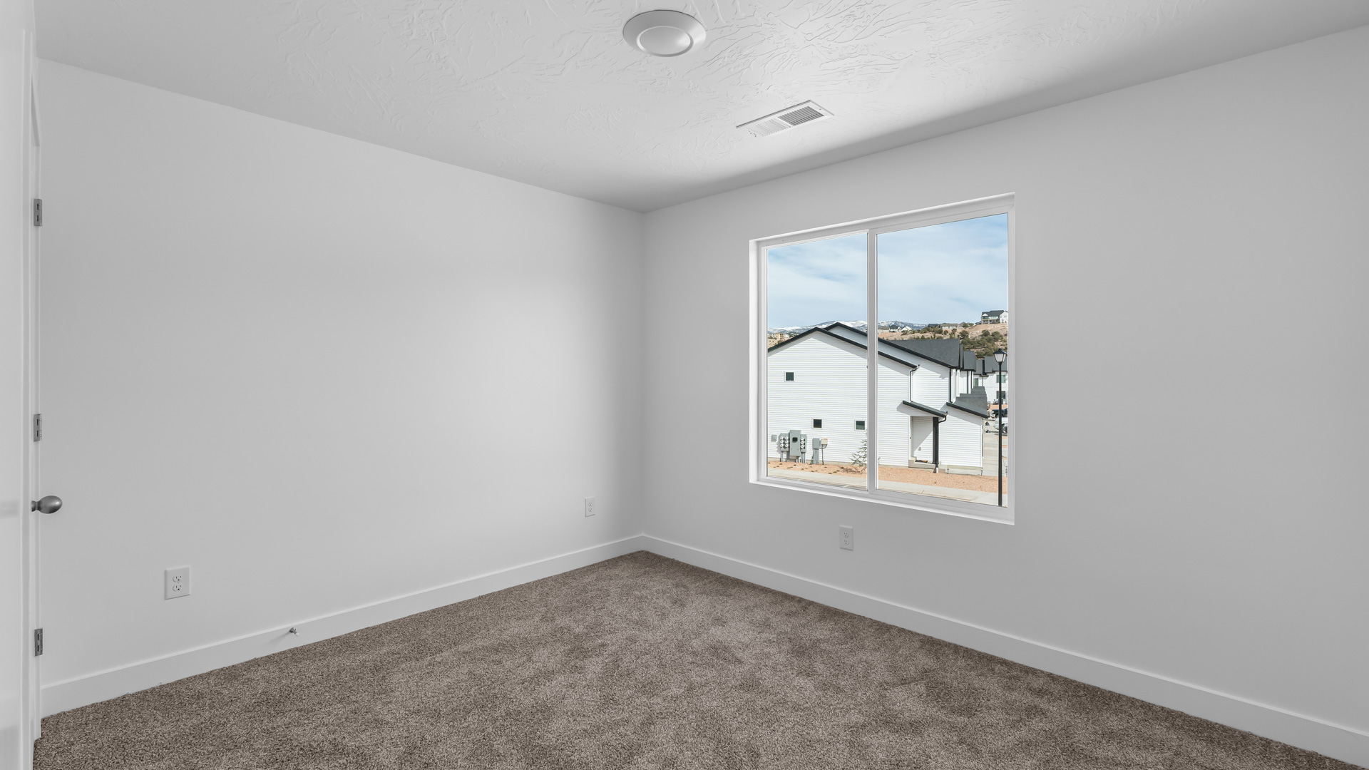Bedroom with large window.