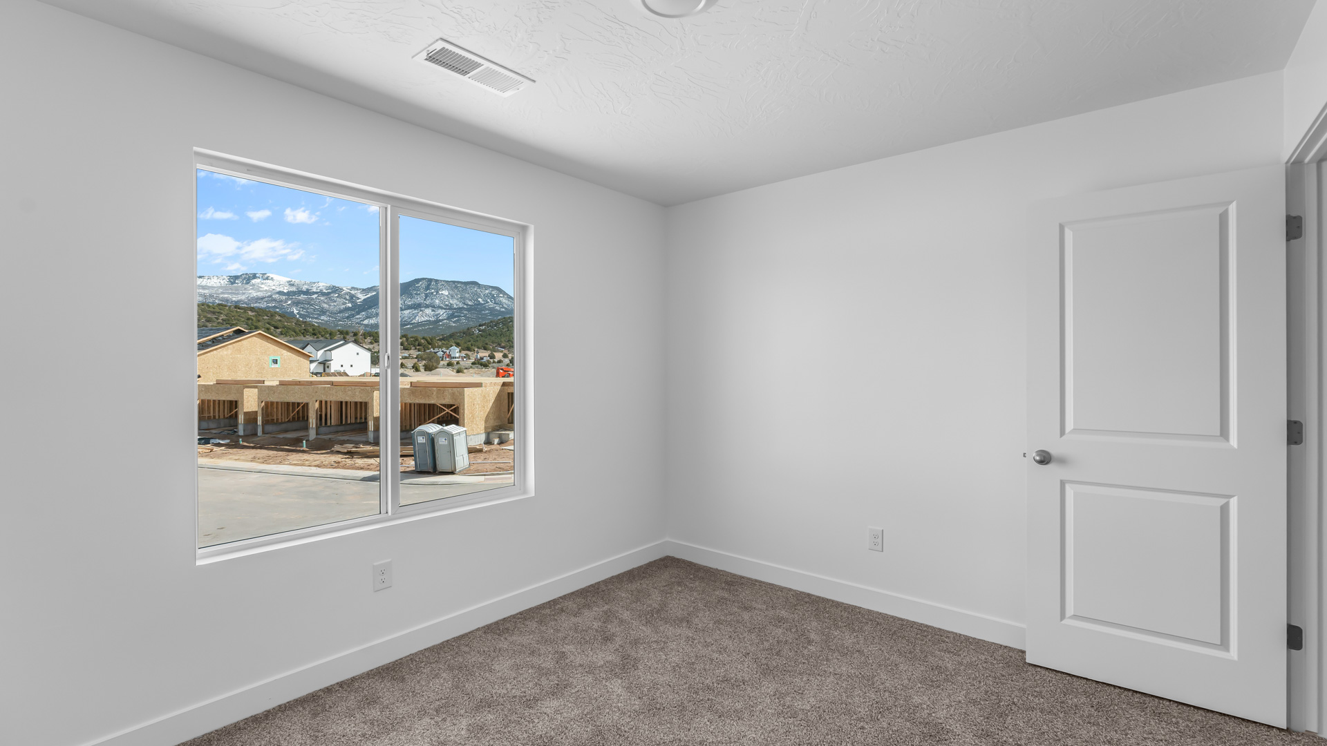 Bedroom with large window.