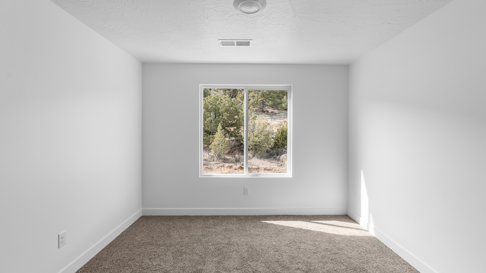 Bedroom with large window.