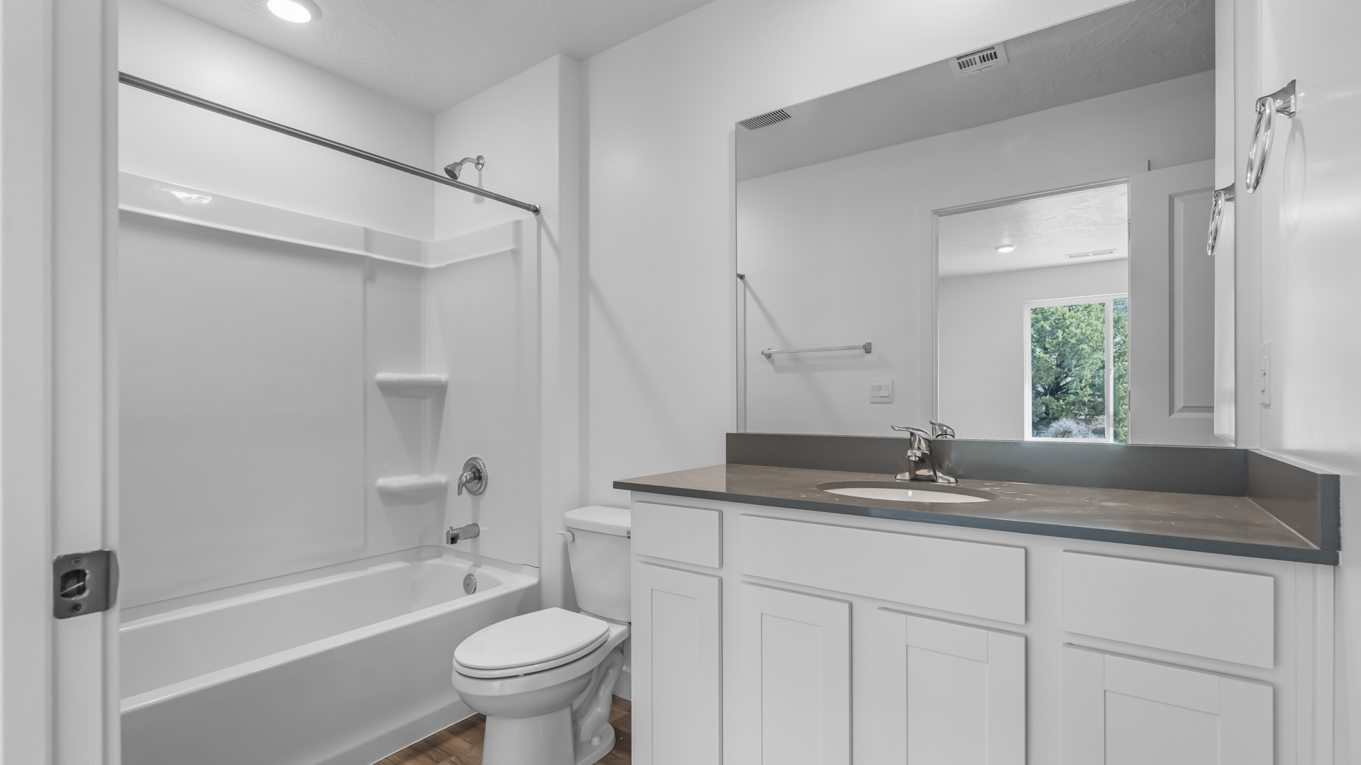 Primary bathroom with shower surround.