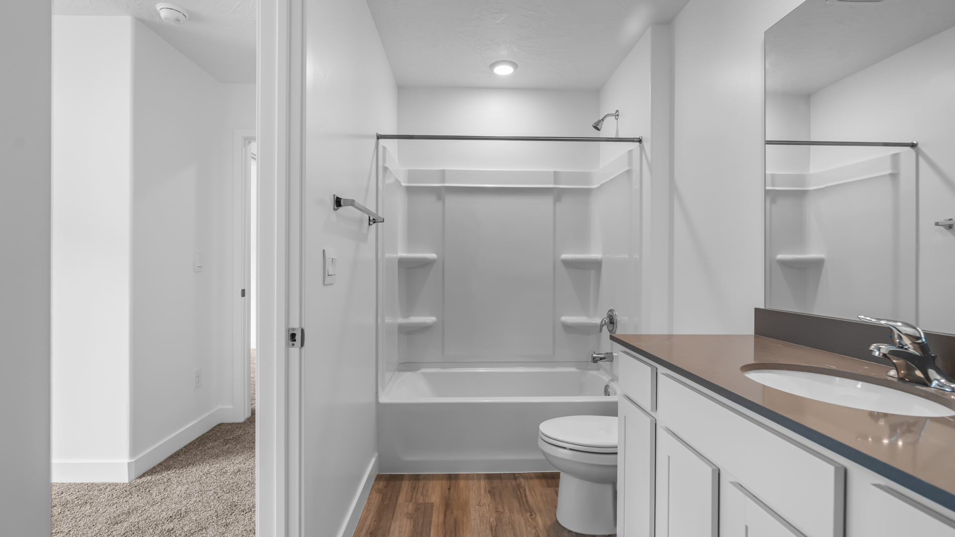 Primary bathroom with shower surround.