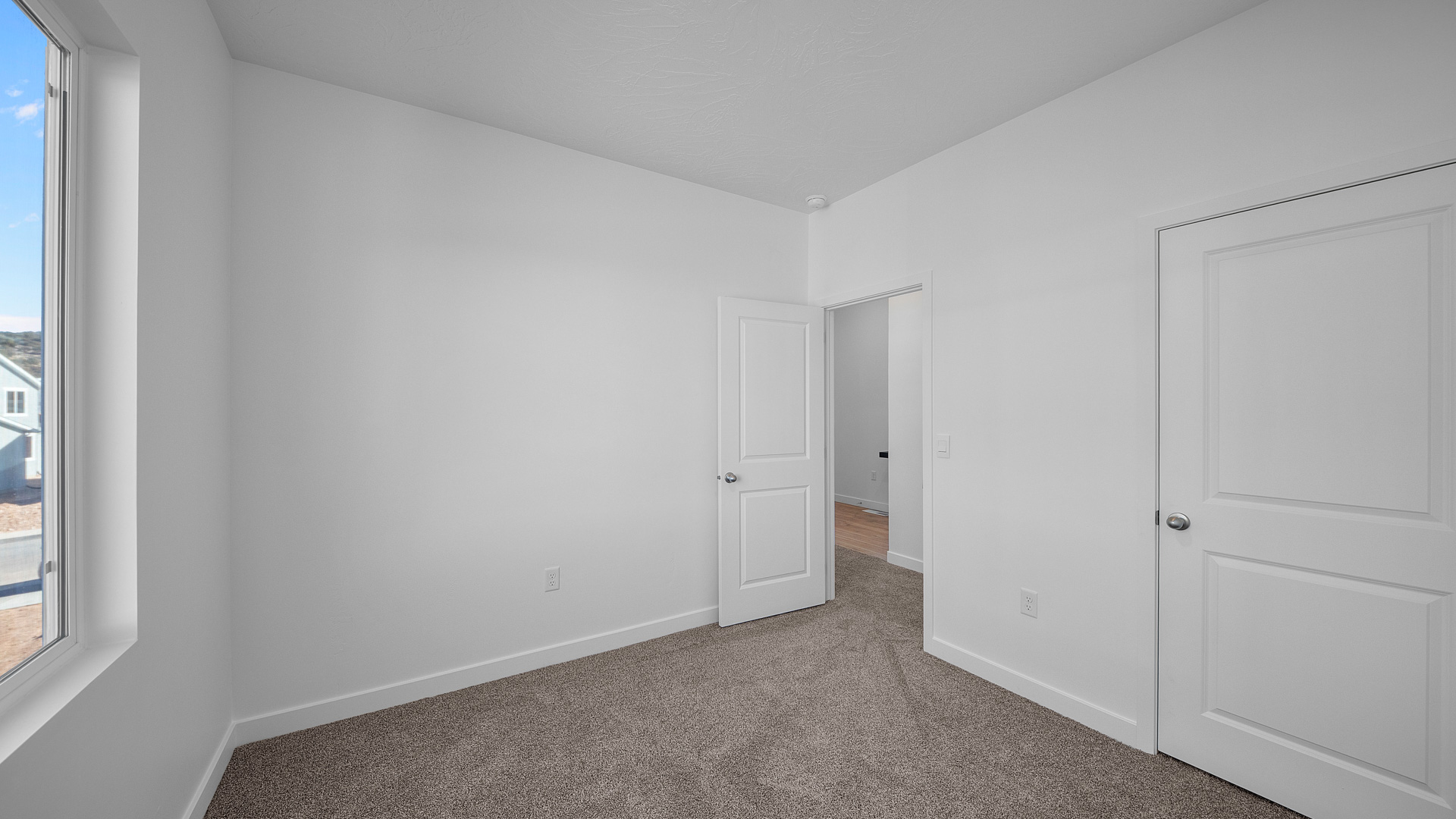 Bedroom with large window.