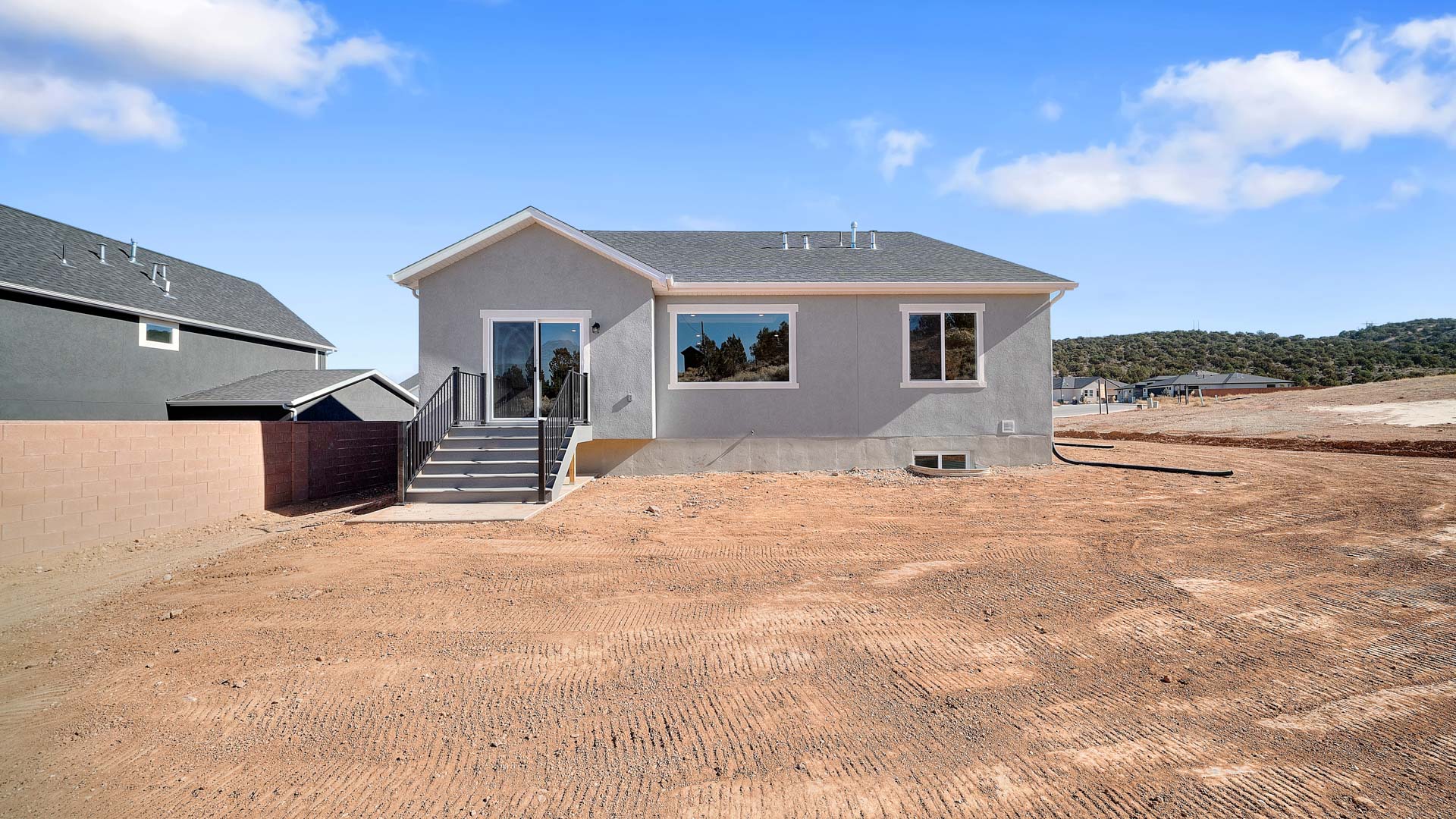 Back of home with patio.