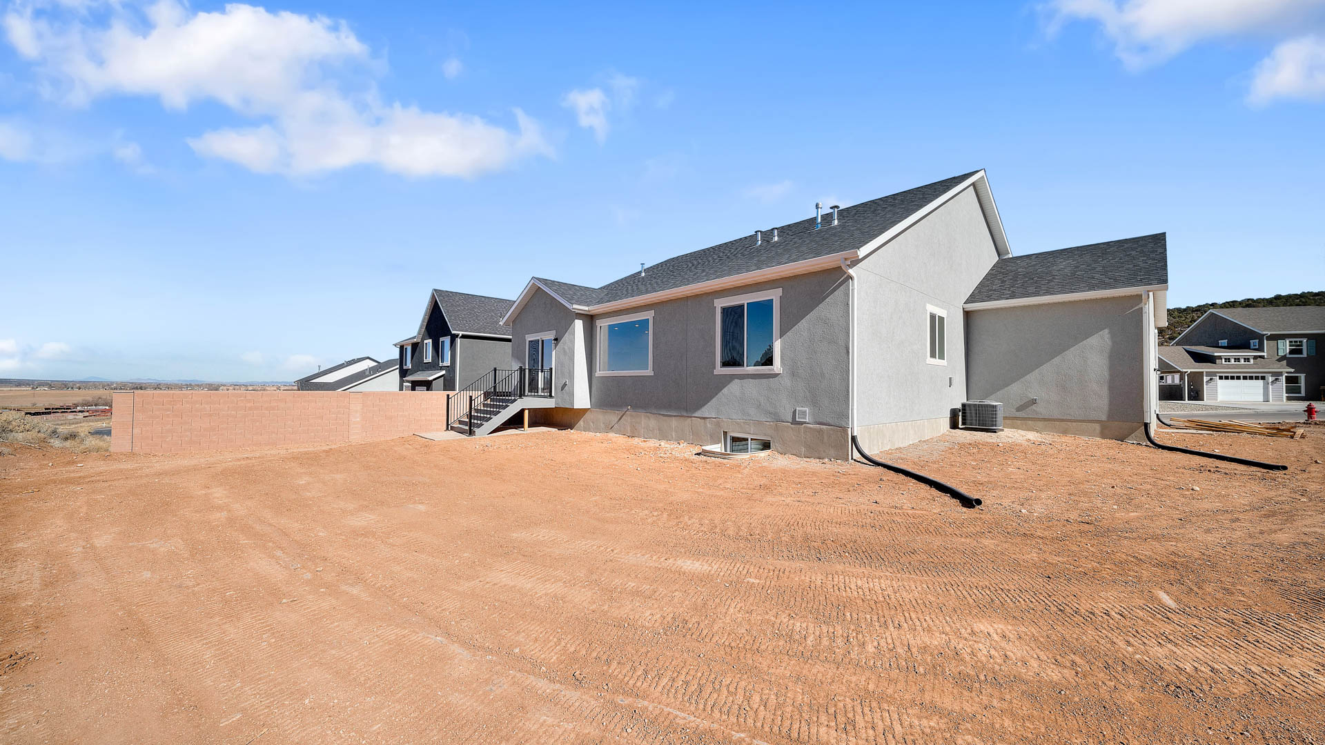 Back of home with patio.