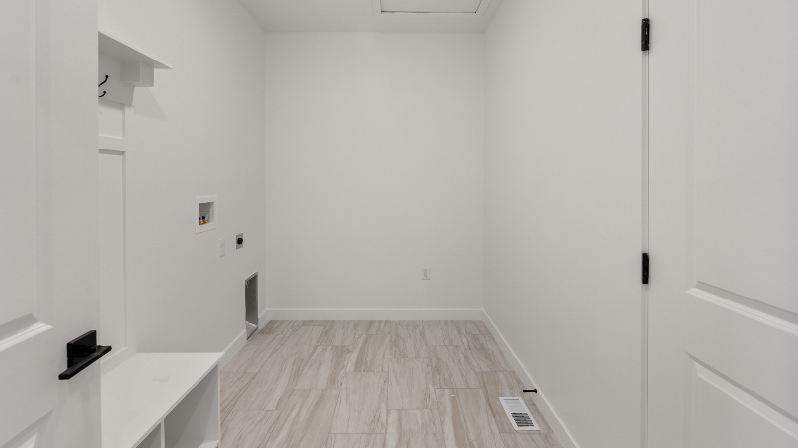 Laundry room and mudroom with storage bench.
