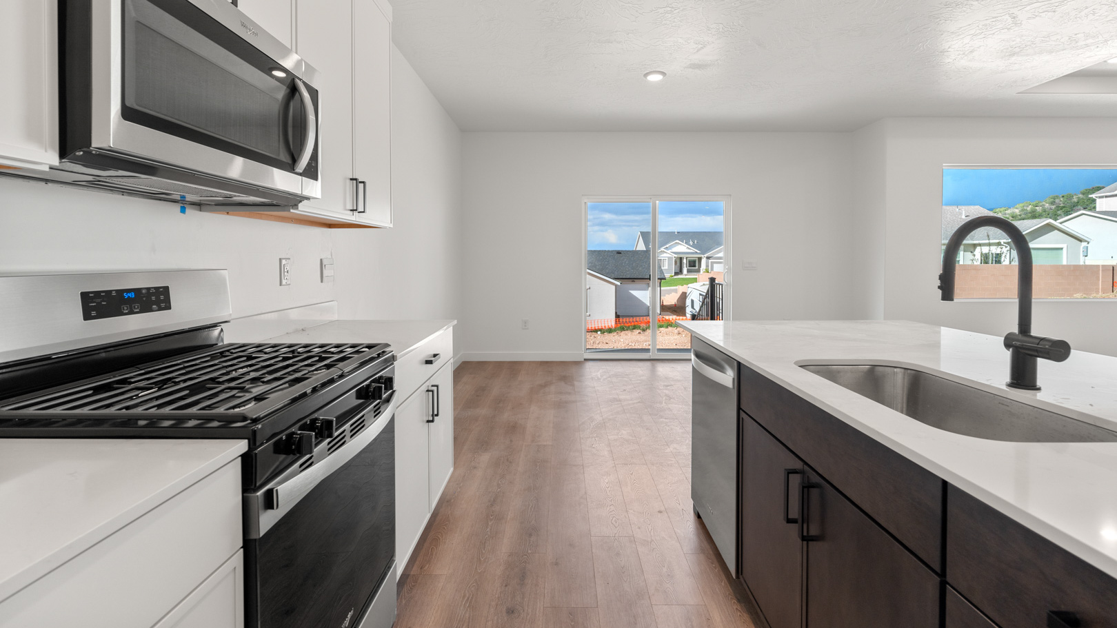 Kitchen island with sink and stainless steel appliances.
