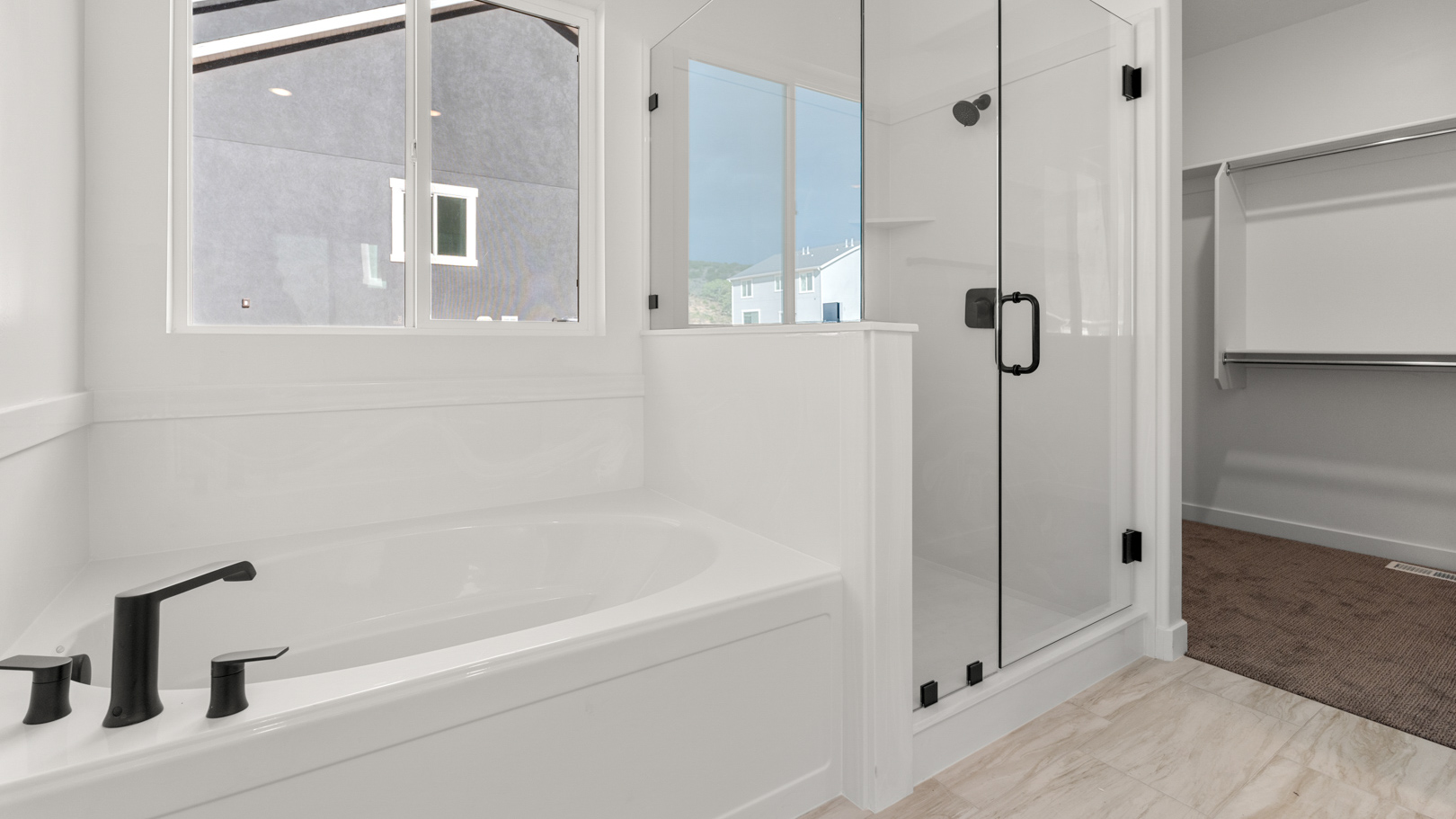 Primary bathroom with tub and glass shower.