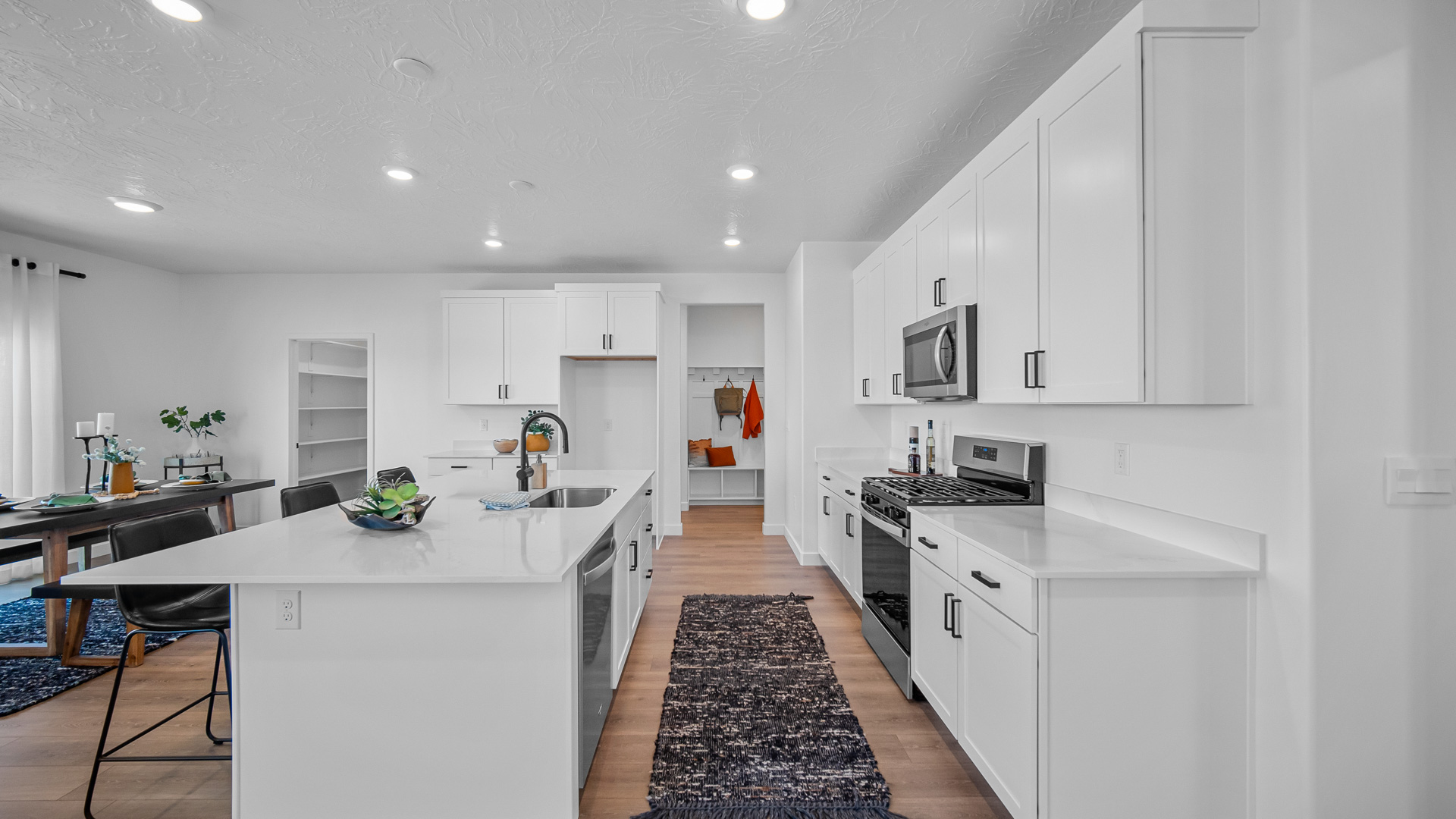 Kitchen with kitchen island featuring sink and stainless steel appliances.