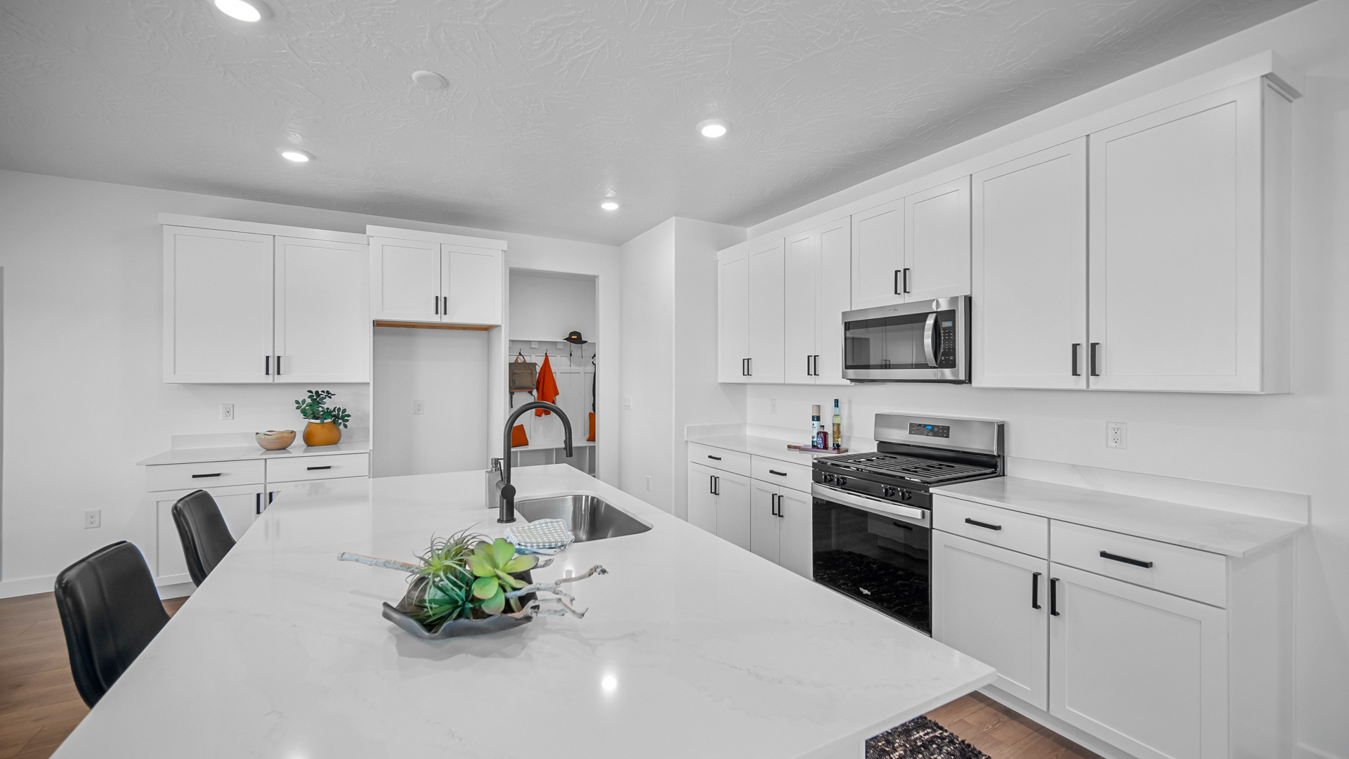 Kitchen with kitchen island featuring sink and stainless steel appliances.