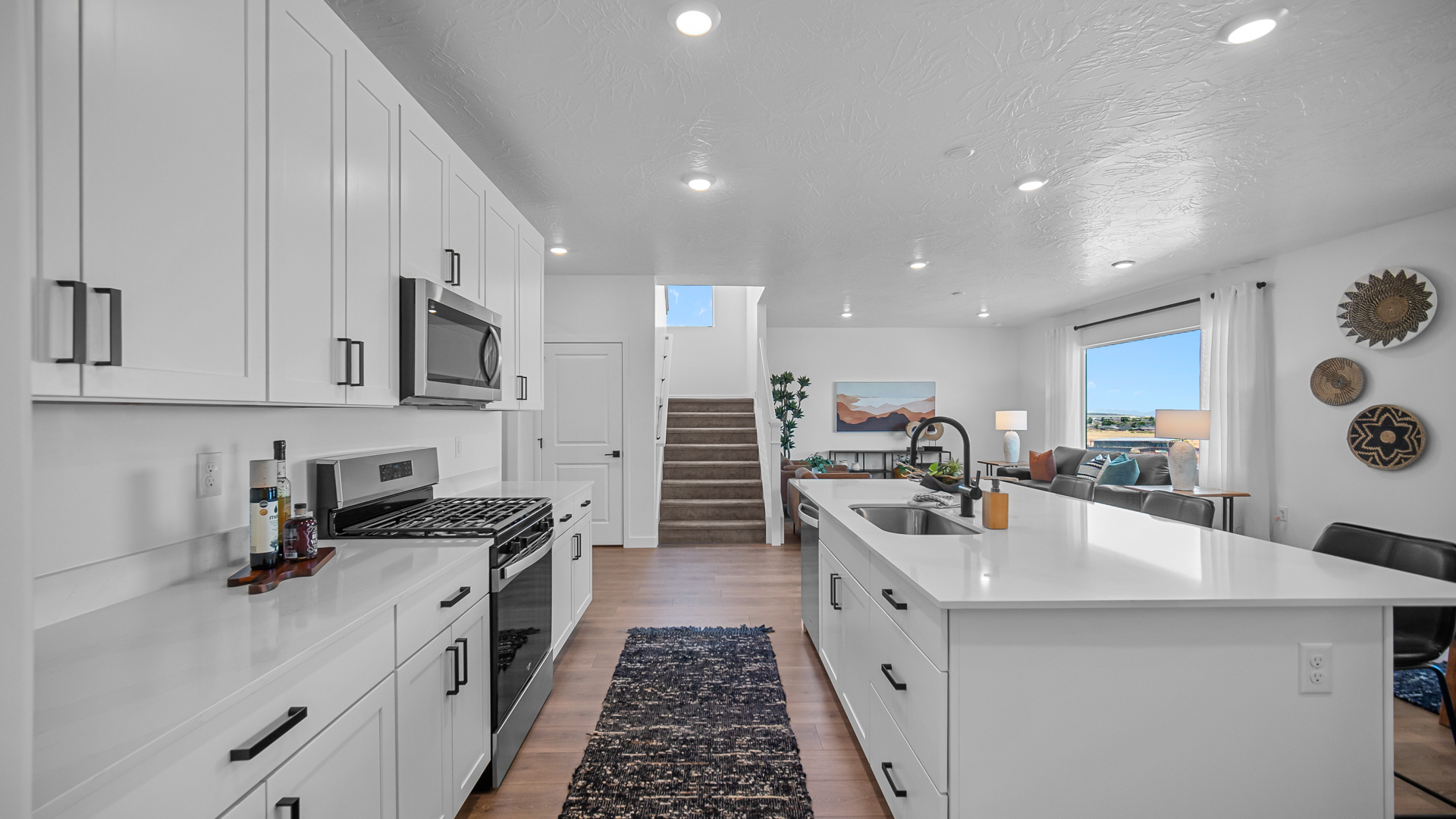 Kitchen with kitchen island featuring sink and stainless steel appliances.