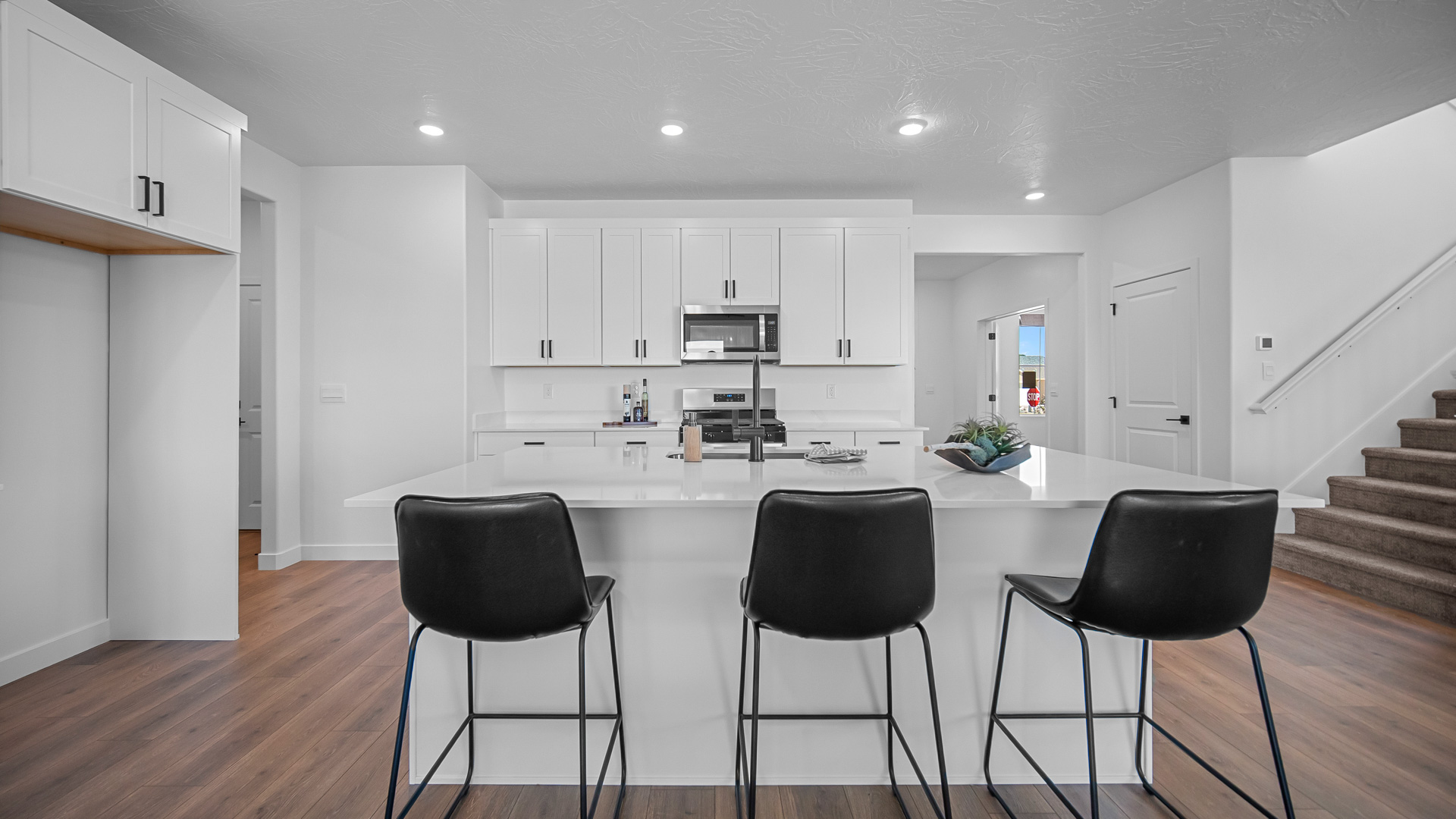 Kitchen with kitchen island featuring sink and stainless steel appliances.