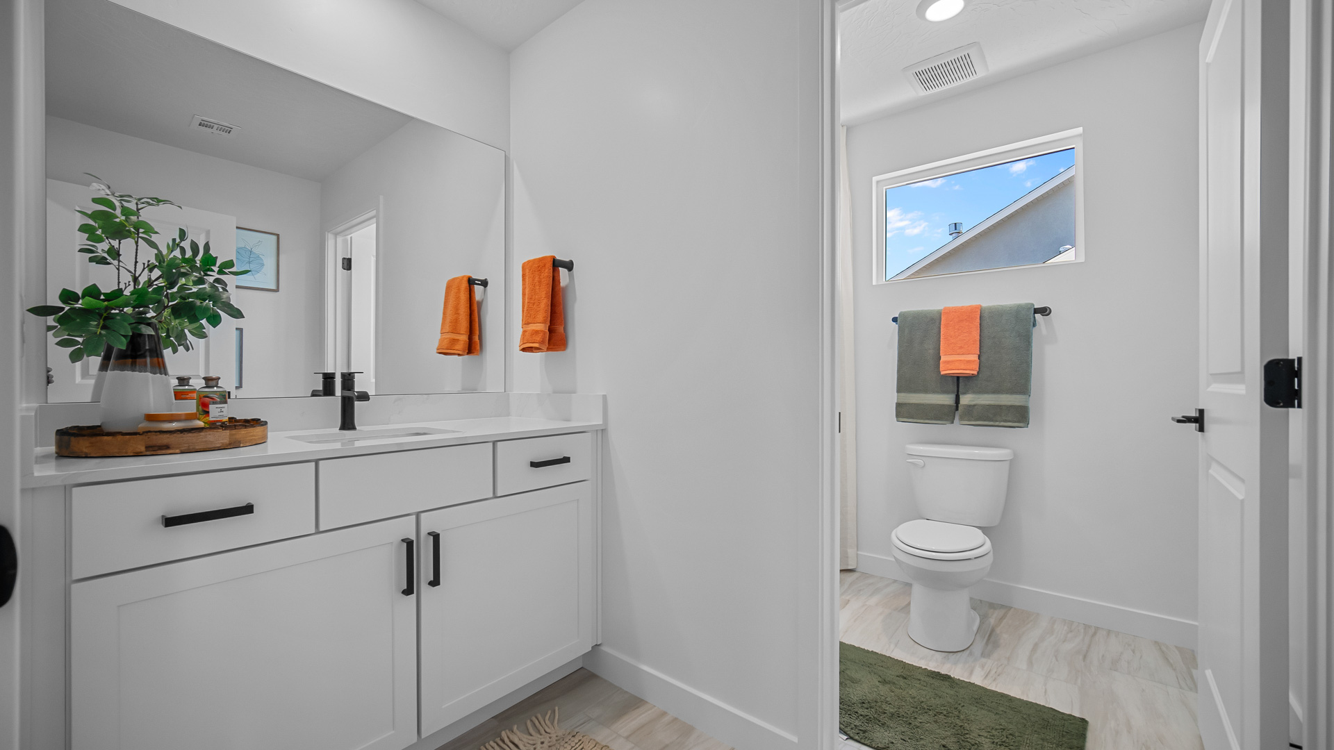 Bathroom with window and shower surround.