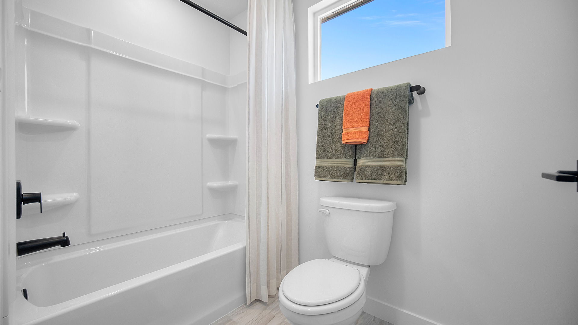 Bathroom with window and shower surround.