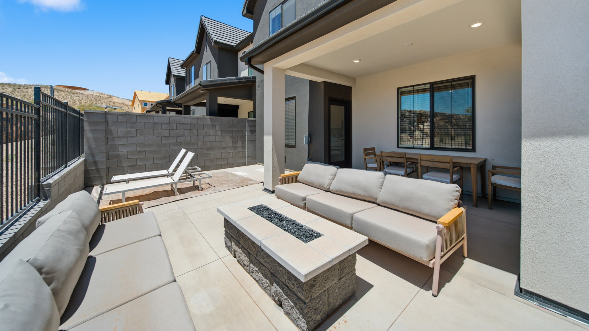 Back of home with patio.