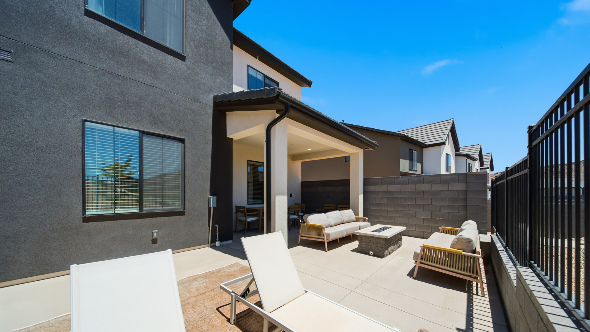 Back of home with patio.
