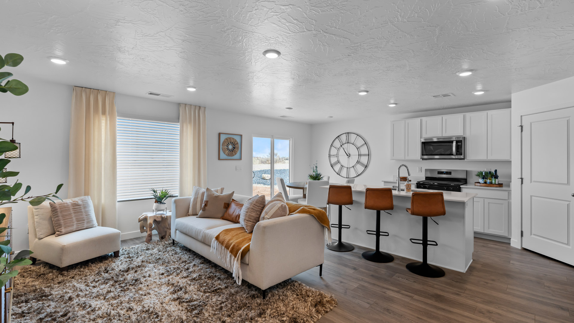 Main living area with kitchen featuring island and stainless steel appliances.