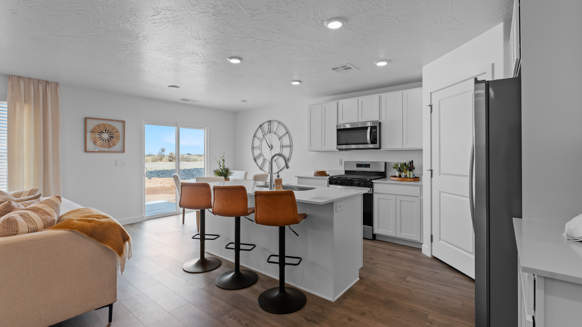 Spacious kitchen with cabinets, island, and stainless steel appliances.