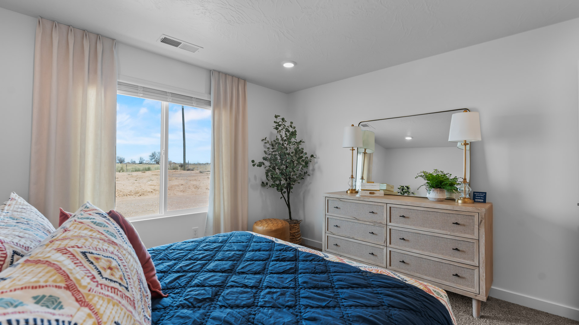 Primary bedroom with large window.