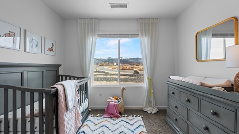 Another angle of bedroom with large window.
