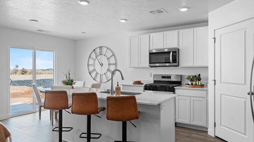Spacious kitchen with cabinets, island, and stainless steel appliances.