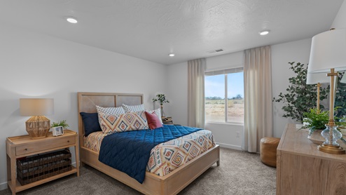 Primary bedroom with large window.
