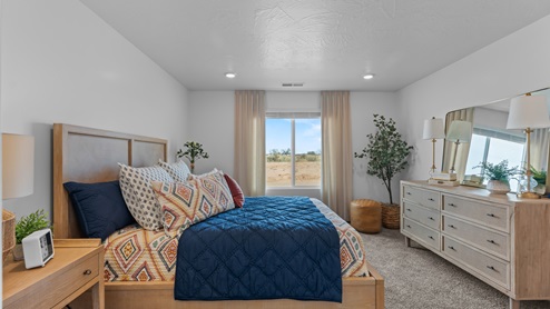 Primary bedroom with large window.