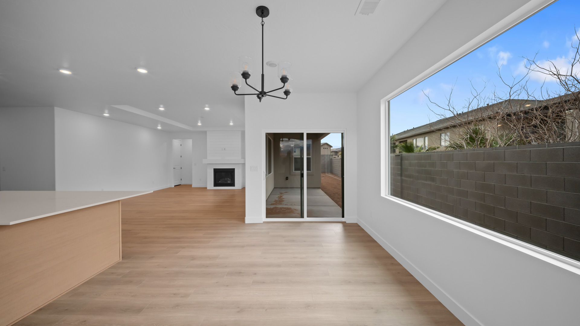 Dining space with large window and glass patio doors.