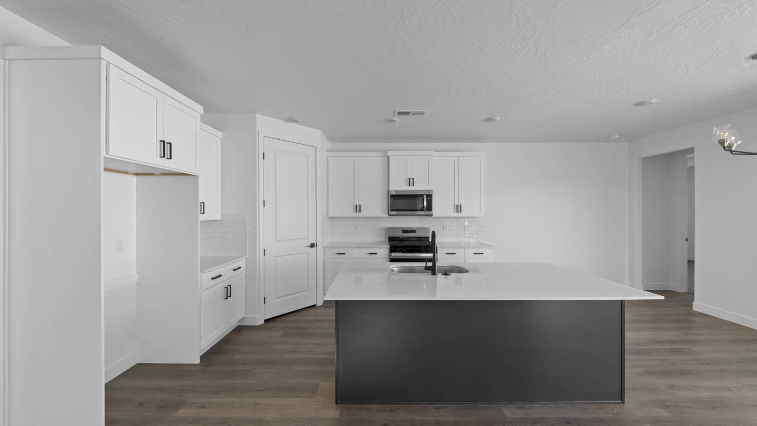 Kitchen with kitchen island and cabinets.