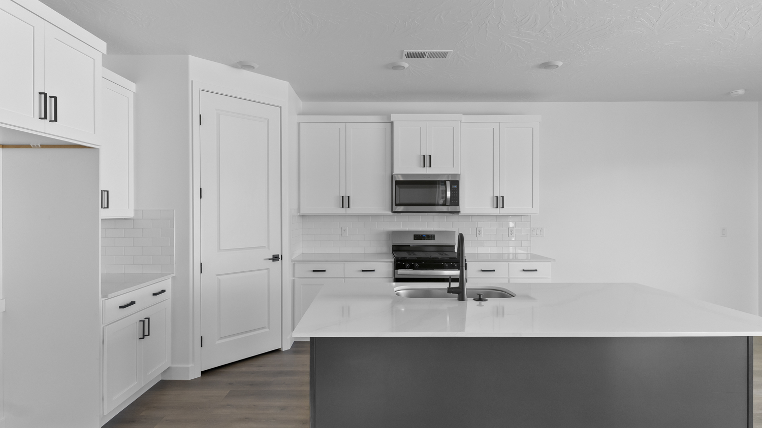 Kitchen with kitchen island and cabinets.