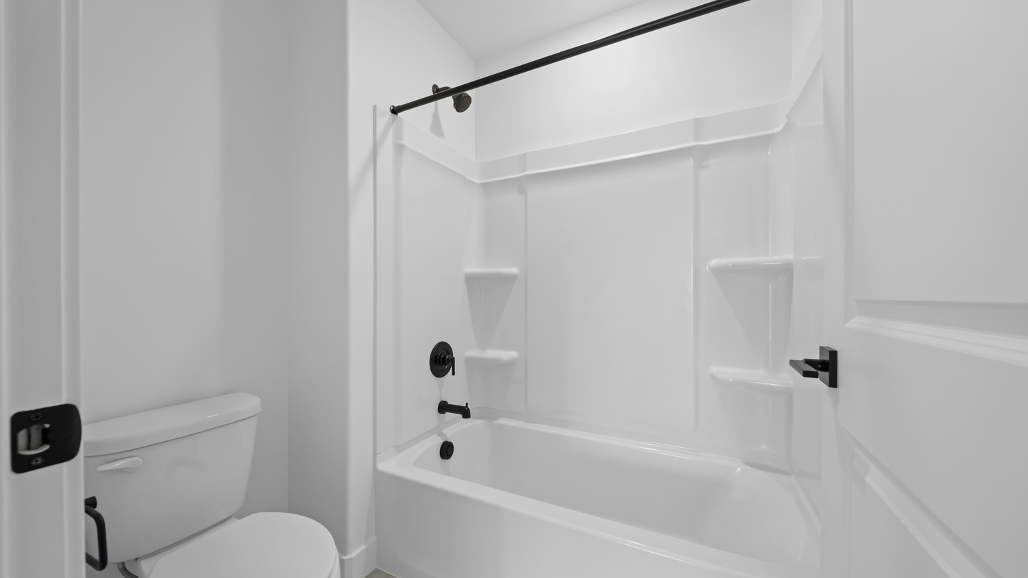 Bathroom with vanity and shower surround.