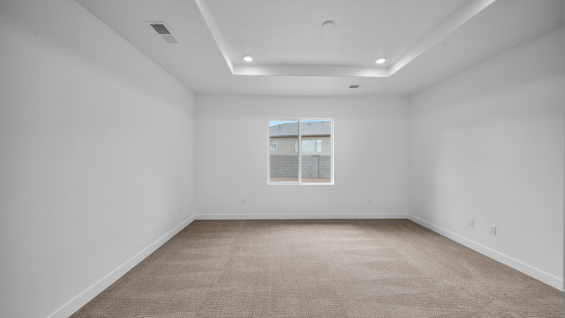 Primary bedroom with tray ceiling.