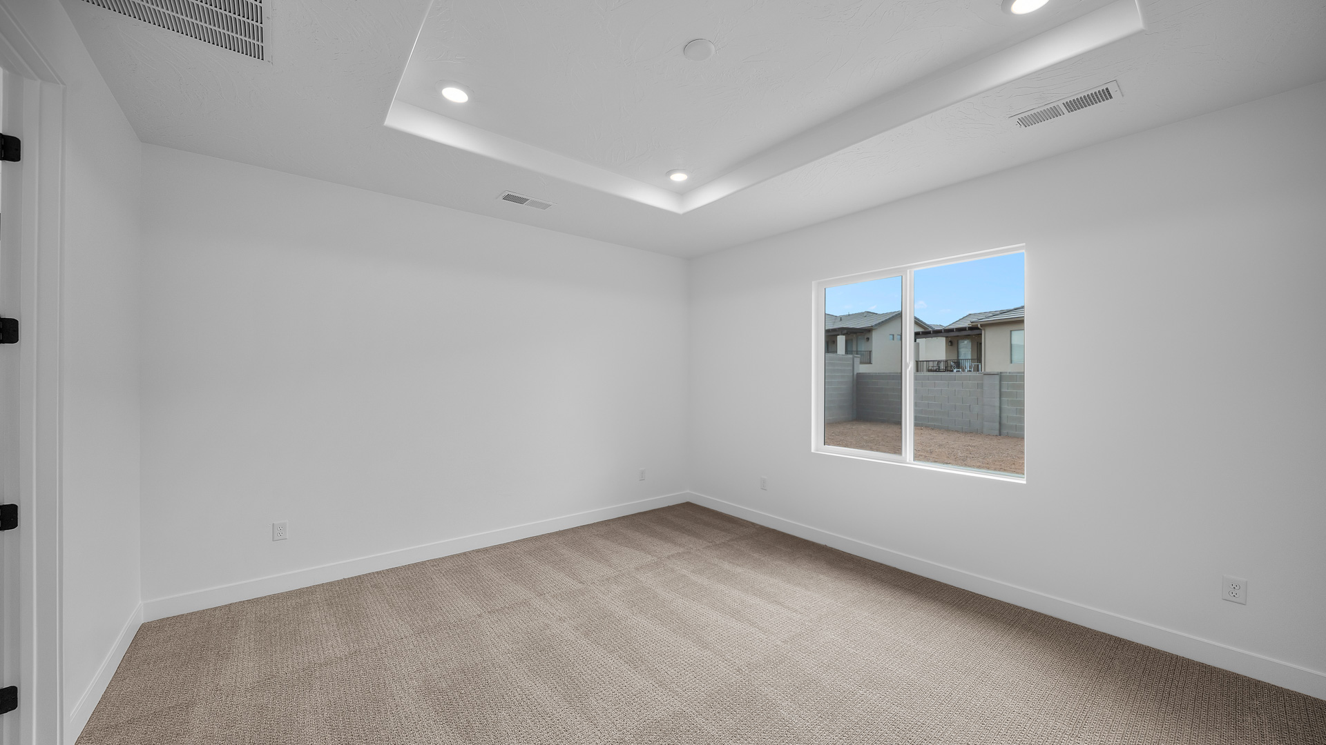 Primary bedroom with tray ceiling.