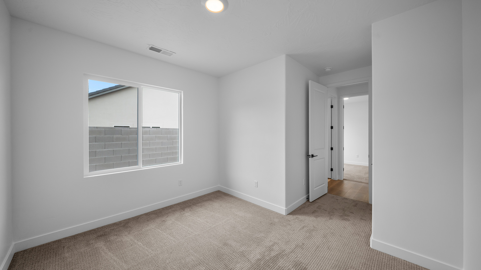 Bedroom with large window.